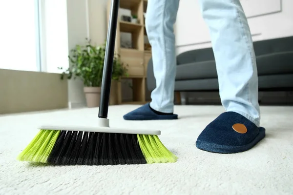 Young Man Sweeping Carpet Broom Home Closeup — Stock Photo, Image