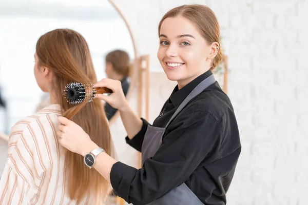 Female Hairdresser Brushing Young Woman Hair Beauty Salon — Stock Photo, Image