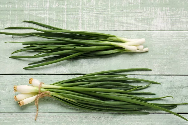 stock image Fresh green onion on wooden background