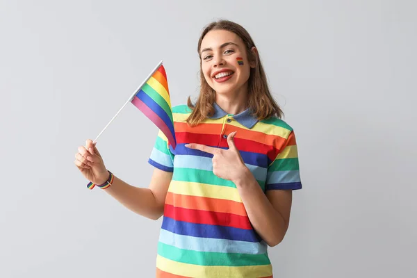 Young Woman Pointing Lgbt Flag Light Background — Stock Photo, Image