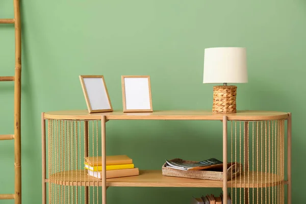 Stylish Wooden Shelving Unit Blank Frames Lamp Books Ladder Green — Stock Photo, Image