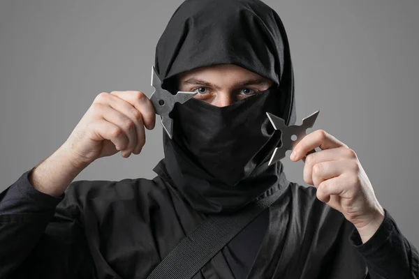 Male Ninja Shurikens Grey Background — Stock Photo, Image