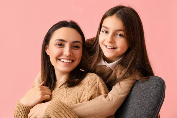 小さな女の子と彼女の母親で編んだセーターに抱きしめピンクの背景 クローズアップ — ストック写真