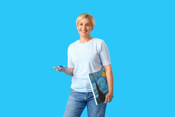 Mature Female Artist Picture Tools Blue Background — Stock Photo, Image