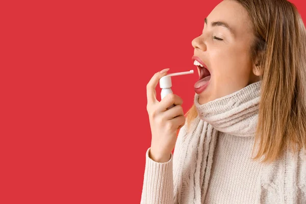 Ill Young Woman Spray Sore Throat Red Background Closeup — Stock Photo, Image