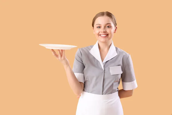 Young Waitress Empty Plate Beige Background — Stock Photo, Image