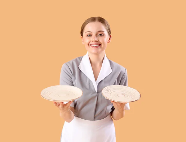 Beautiful Young Waitress Empty Plates Beige Background — Stock Photo, Image