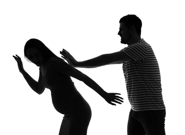 stock image Silhouette of man beating his pregnant wife on white background. Domestic violence concept