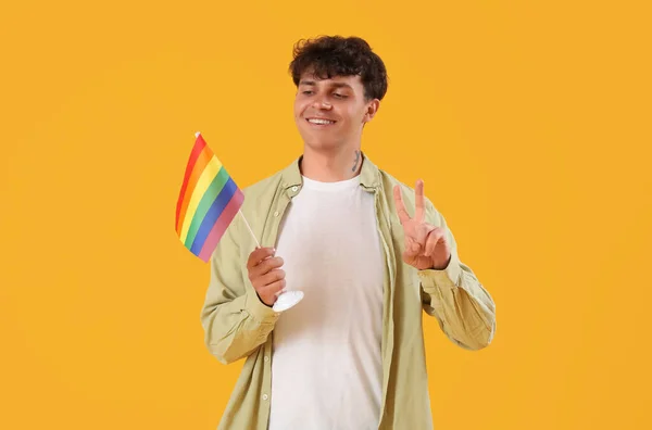 Young Man Lgbt Flag Showing Victory Gesture Yellow Background — Stock Photo, Image
