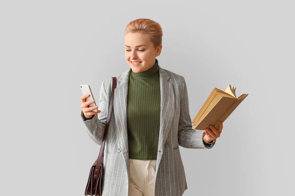 Female Student Book Mobile Phone Light Background — Stock Photo, Image