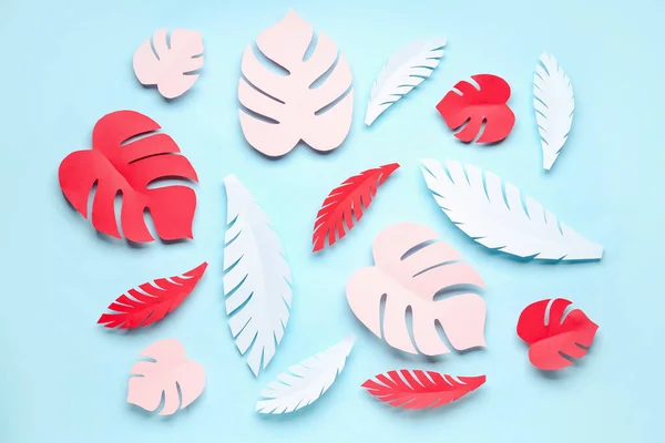 stock image Paper tropical leaves on blue background