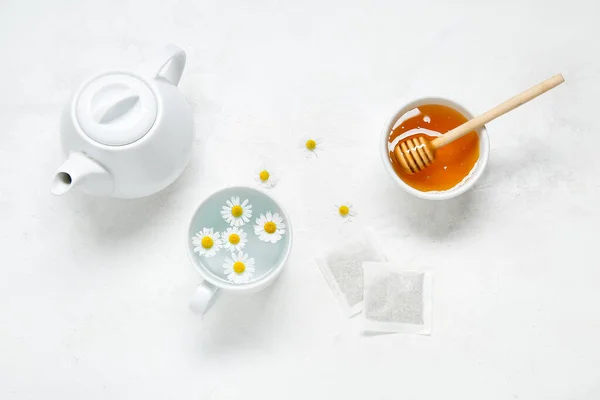 Composition Teapot Cup Water Chamomile Flowers Honey Tea Bags Light — Stock Photo, Image