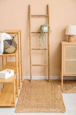 Raflar, merdiven, çekmeceler ve hasır halıları olan şık bir oturma odası.