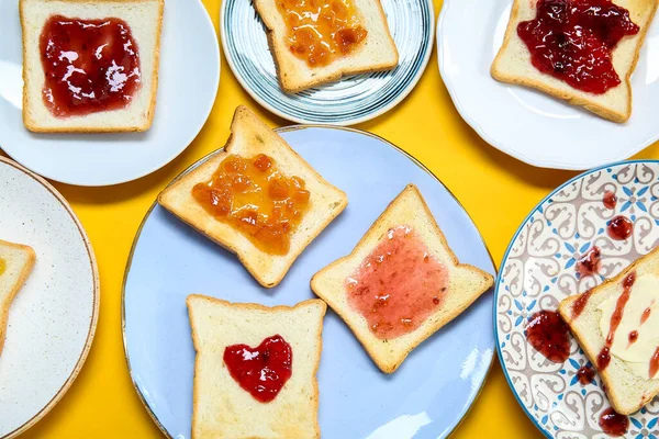 Many Plates Delicious Toasts Jam Color Background Closeup — Stock Photo, Image
