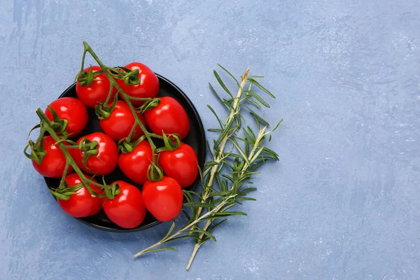 stock image Tray with fresh cherry tomatoes and rosemary on blue background