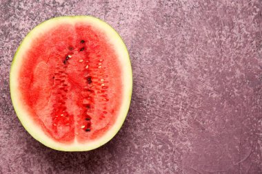 Mor arka planda taze karpuzun yarısı.