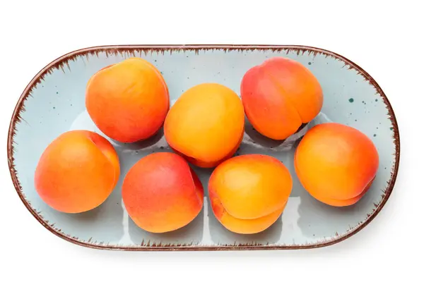 stock image Plate with ripe apricots isolated on white background