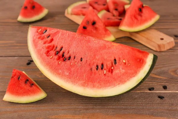 stock image Pieces of fresh watermelon and seeds on wooden table