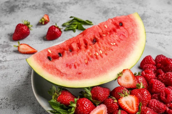 stock image Plate with piece of fresh watermelon and different berries on grey background