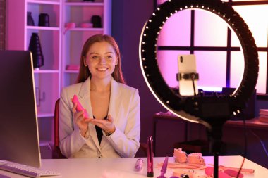 Female blogger with vibrator conducting sex education online at home