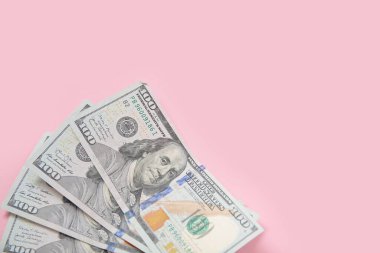 Pembe arka planda 100 dolarlık banknotlar