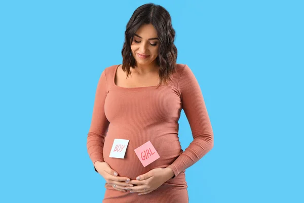Young Pregnant Woman Words Boy Girl Papers Blue Background — Stock Photo, Image