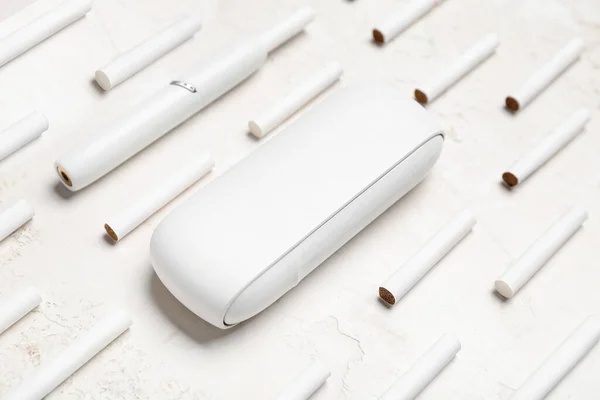 stock image Composition with modern electronic cigar and many sticks on white table