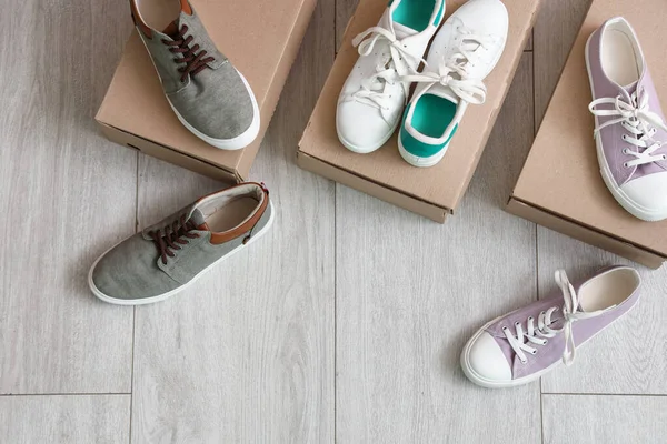 Cardboard Boxes Different Stylish Sneakers Light Wooden Background — Stock Photo, Image