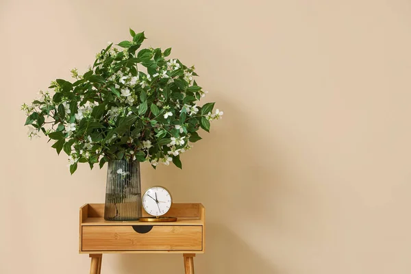 Vase Blooming Jasmine Flowers Alarm Clock Wooden Table Beige Wall — Stock Photo, Image