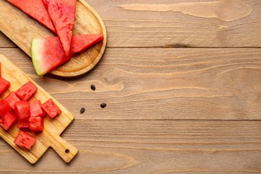 Tahta zemin üzerinde taze karpuz parçaları olan tahtalar.