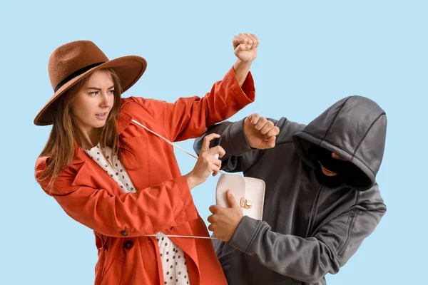 Young Woman Pepper Spray Defending Herself Thief Blue Background — Stockfoto