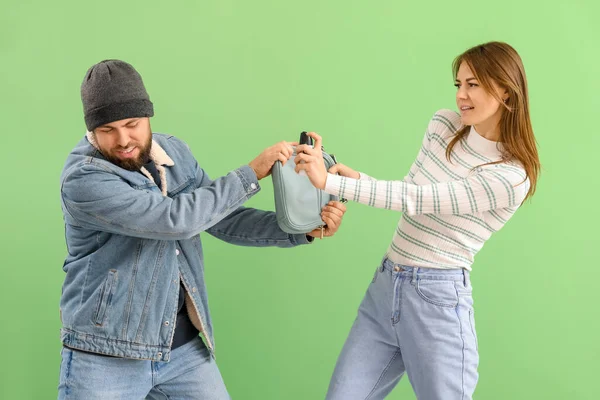 Young Woman Pepper Spray Defending Herself Thief Green Background — Stockfoto