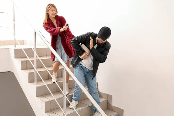 Young Woman Pepper Spray Defending Herself Thief Stairway — Stockfoto