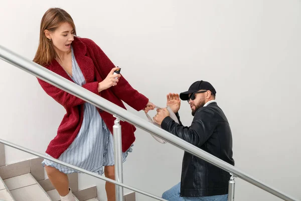 Young Woman Pepper Spray Defending Herself Thief Stairway — Stockfoto