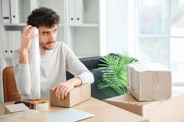 Young Man Stretch Wrap Cardboard Box Film Office — Stock Photo, Image