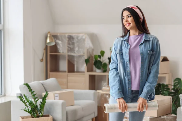 Young Woman Roll Stretch Wrap Home Moving Day — Stock Photo, Image