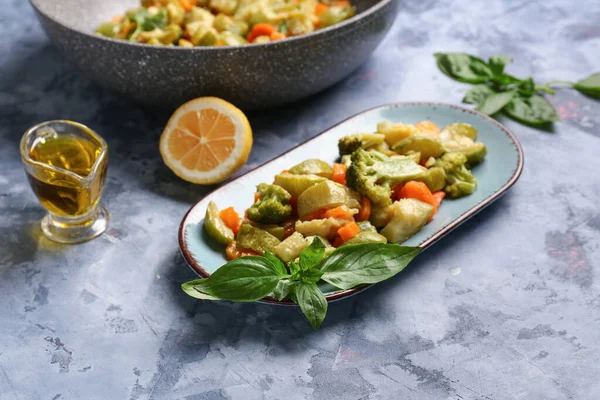 stock image Plate with different vegetables on blue background