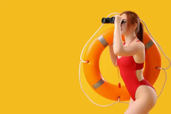 Female Lifeguard Binoculars Ring Buoy Yellow Background — Stock Photo, Image