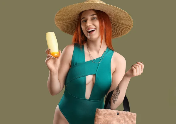 Młoda Kobieta Kremem Opalania Torbą Plażową Zielonym Tle — Zdjęcie stockowe