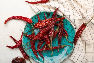 Kuru kırmızı biberli tabak ve beyaz arka planda dilimlenmiş biber.