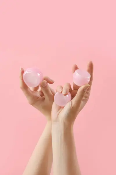 Hands Holding Jars Cosmetic Cream Pink Background — Stock Photo, Image