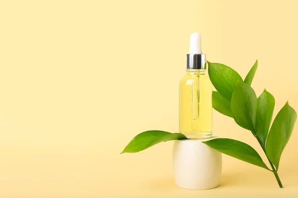Bottle Cosmetic Oil Plant Twig Stand Yellow Background — Stock Photo, Image