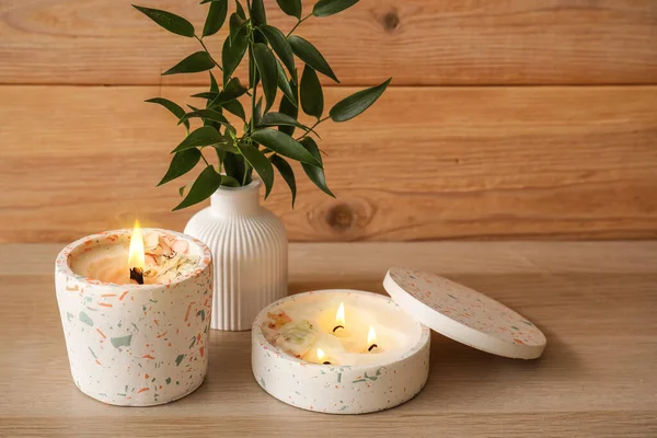 Beautiful Branch Burning Candles Table Wooden Wall Room Closeup — Stock Photo, Image