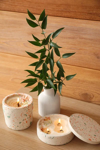 Beautiful Branch Burning Candles Table Wooden Wall Room Closeup — Stock Photo, Image