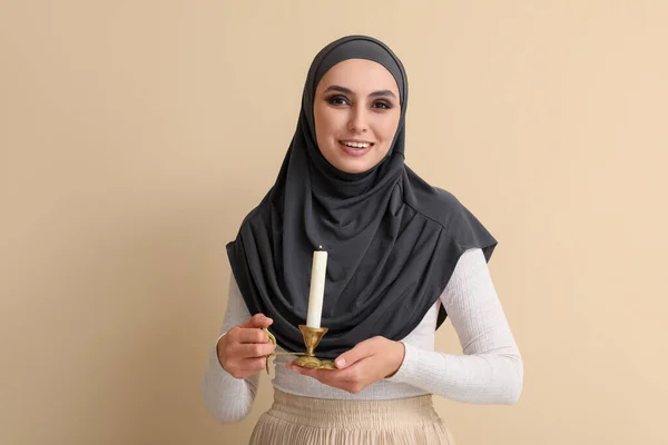 Young Muslim Woman Burning Candle Beige Background Islamic New Year — Stock Photo, Image