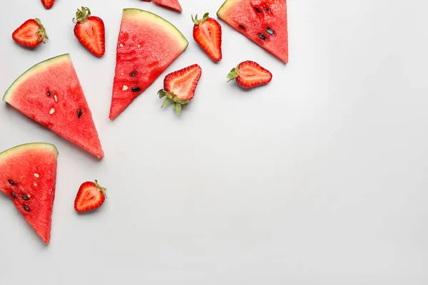 stock image Pieces of fresh watermelon and strawberries on grey background