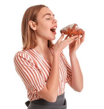 Female baker with tasty croissant on white background