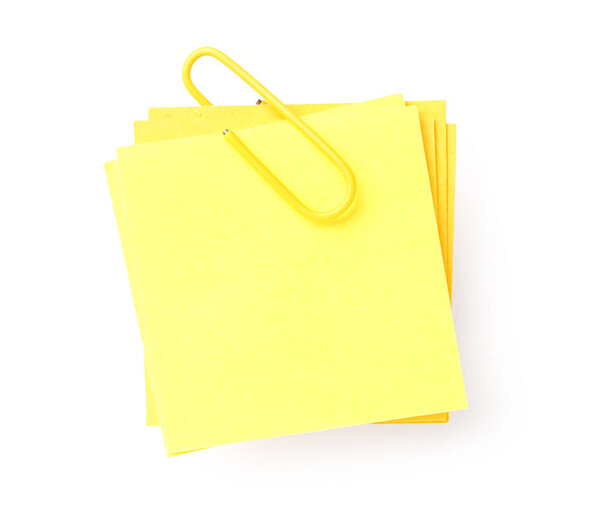 Yellow sticky note with paper clip on white background