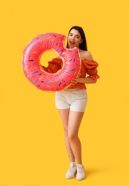 Young Woman Inflatable Ring Shape Doughnut Orange Background — Stock Photo, Image