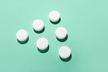 Yeşil arka planda beyaz haplar